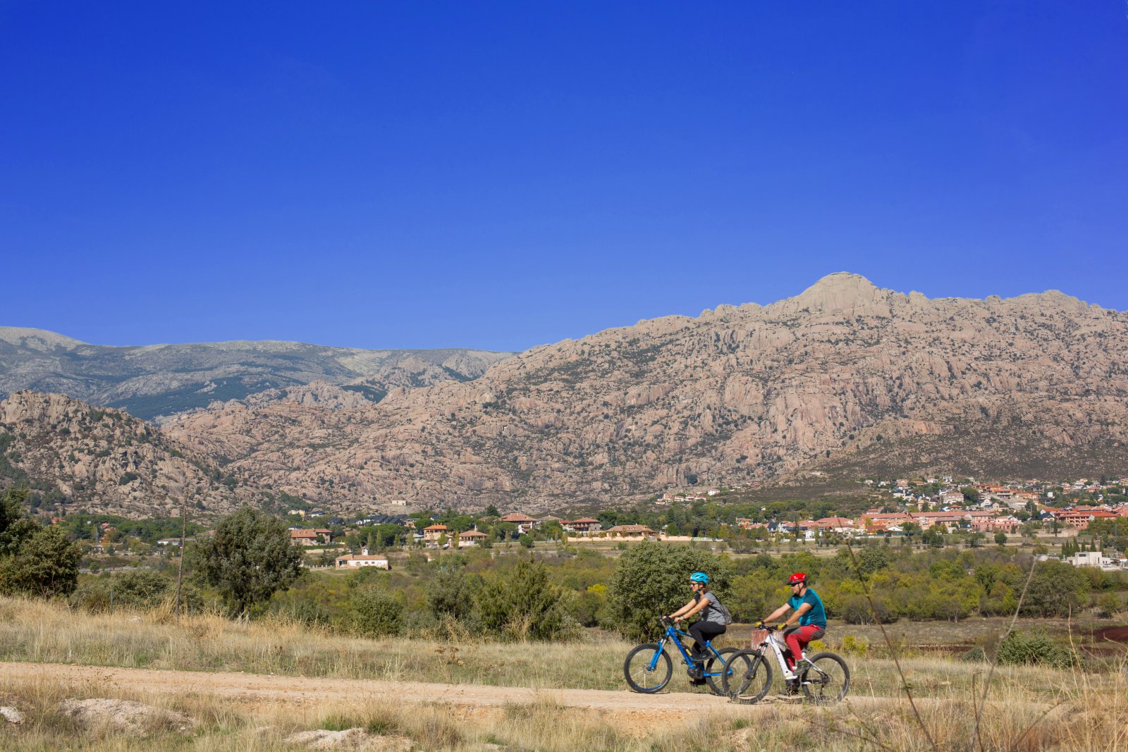 Dos ciclistas con la sierra al fondo